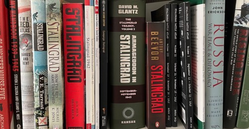 A photo of a bookshelf full of various books about Stalingrad