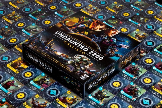 A photo of the Undaunted 2200: Callisto box surrounded by carefully arranged cards