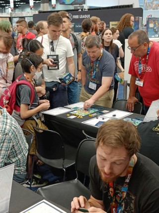 A photo of co-designer David Thompson demo-ing General Orders: World War II to a crowd at the Gen Con 2023 convention