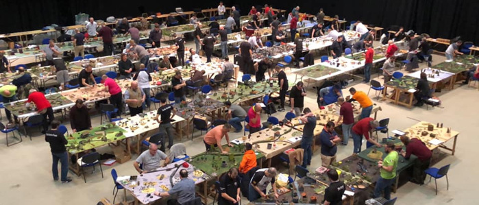 A photo of a packed room of game tables with people playing the Bolt Action WW2 wargame