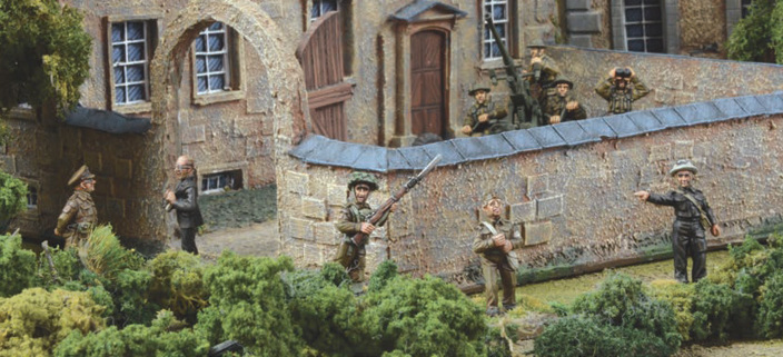 A photo of fully painted miniature figures and terrain for wargaming: WW2 British Home Guard members