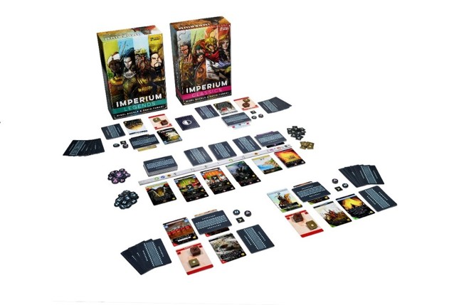 A photo of the game boxes for Imperium: Legends and Imperium: Classics stood side by side in front of a fully set-up game of cards and tokens