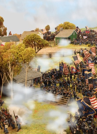 A photo of fully painted miniature figures and terrain set up as a mass American Civil War battle, with gunsmoke hanging in the air between the two armies.