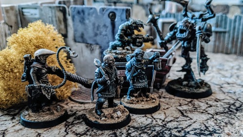 A photo of a varied selection of fully painted miniature figures used for playtesting The Doomed by author Chris McDowall