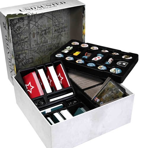 A photograph of the Undaunted: Stalingrad game box opened to reveal a multi-layered insert holding tokens, multiple decks of cards and a huge number of board tiles - and the interior art of the lid showing an annotated battle map of the city